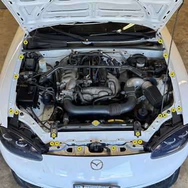 Stage 1 titanium engine bay hardware kit installation diagram for 1999-2005 Mazda Miata NB — yellow markers show fastener locations at headlight mounts, fenders, and radiator stays